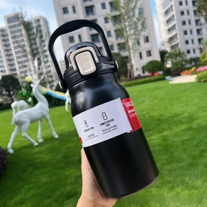 Close-up of matte black 304 stainless steel thermos with handle and flip-top straw lid