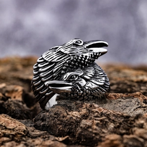 Vintage silver double eagle head ring crafted in stainless steel on a rustic wood bark base
