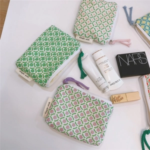 Detail view of cotton floral pouches with Simple Wish tags and colorful zipper pulls
