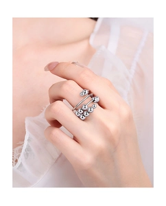Detail of layered fidget ring with spinning silver beads on a model's finger