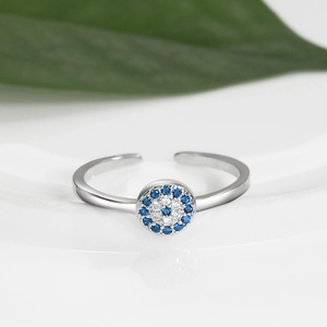Detailed macro view of gold plated evil eye ring with blue and clear zircon crystals