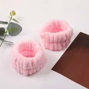 Close-up of pink coral fleece wristbands showing soft high-density absorbent texture