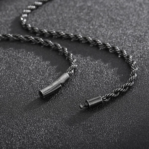 Detailed close-up of dark grey metal twist rope chain necklace featuring a secure lobster clasp