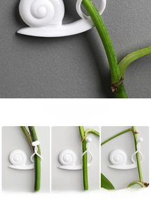 Detailed view of white snail plant clips showing rotating buckles for various vine sizes