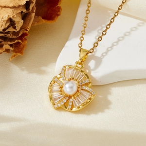 Vue détaillée d'un collier doré vintage avec perle et pierres de zircone scintillantes