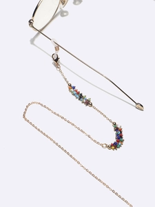 Handmade beaded glasses chain with colorful beads and golden metal link on white background