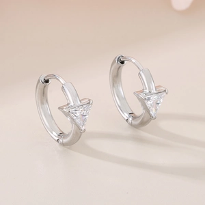 Detailed view of silver hoop earrings featuring sparkling triangle cut cubic zirconia stones