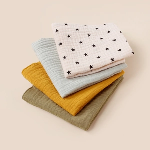 Close-up of 4-pack muslin cotton baby towels showing soft breathable crepe texture