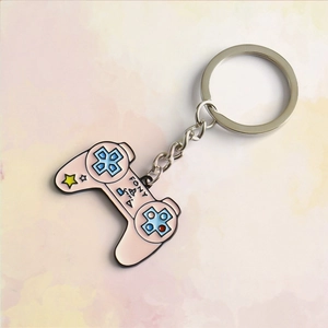 Detailed close-up of pink gaming controller keychain with starry enamel design