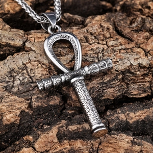 Vintage silver Ankh cross necklace in stainless steel on a textured wood background