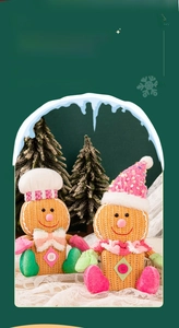 Macro detail of textured corduroy gingerbread man dolls with festive Christmas accessories