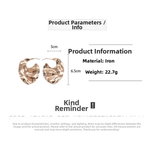 Détail de boucles d'oreilles dorées irrégulières de 5 cm sur 6,5 cm, en fer robuste