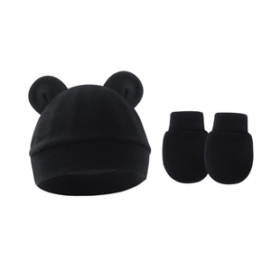 Close-up of black cotton knit newborn hat with bear ears and matching anti-scratch mittens