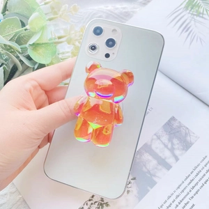 Detail shot of a holographic resin 3D bear phone grip mounted on a modern smartphone