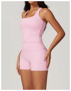 Detailed close-up of pink racerback yoga top and high-waisted fitness shorts set