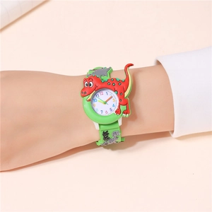 Close-up of 3D dinosaur cartoon watch on wrist featuring green silicone strap with footprints