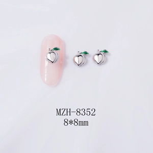 Detailed view of peach-shaped nail art charms with dimensions 8x8mm and silver finish