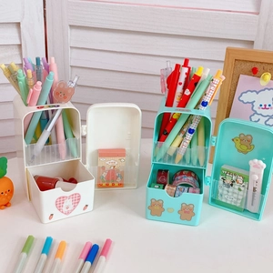 Detail of cute refrigerator shaped pen holders with animal stickers and drawer storage