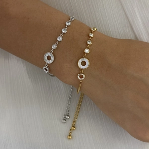 Elegant gold and silver sun-moon bracelets with shell and zircon on a wrist