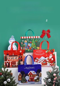 Close-up of waterproof non-woven Christmas gift bags featuring Santa and snowman illustrations