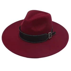 Detail of burgundy wide brim wool felt fedora hat with black leather belt and silver buckle