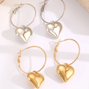 Fashionable gold and silver hoop earrings with oversized 3D heart pendants
