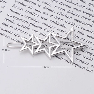 Detail view of silver alloy hair clip with three hollow stars and 6cm size label
