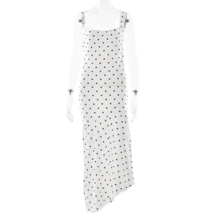 Detailed view of white polka dot dress with cowl neck and asymmetrical split hem
