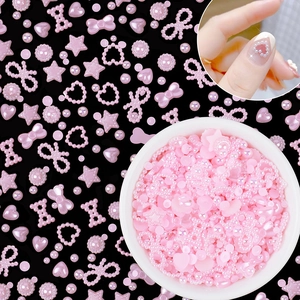 Detailed view of pink resin nail charms set featuring hearts bows and stars shapes