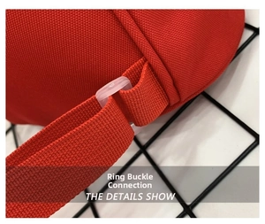 Detail view of durable plastic buckle and reinforced stitching on red kids backpack strap