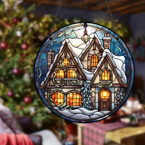 Detail of Christmas acrylic disc featuring a snowy cabin in stained glass art style