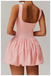 Detailed back view of a pink backless bubble sports dress with pleated skirt
