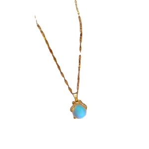 Gold titanium steel necklace with blue gemstone money bag pendant and crystal accents