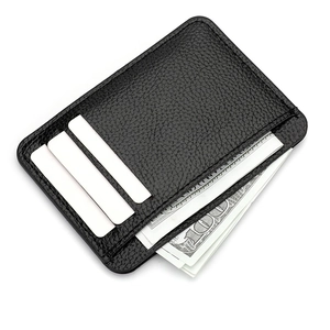 Slim black lychee leather card holder with three slots and a cash compartment for women