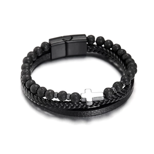 Detail of multi-layer black leather bracelet with lava stone beads and a silver cross
