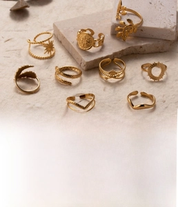 Detailed view of titanium steel gold rings in snake, leaf and sun patterns