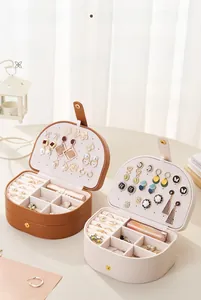 Detail of multi-layer jewelry box with earring panels, ring slots, and lipstick storage