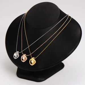 Irregular bean pendant necklace set in gold silver and rose gold polished stainless steel