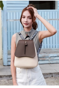 Fashionable contrast color PU leather backpack with letter-print wide straps on model