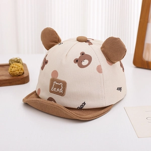 Detail of baby corduroy cap with bear ears, polka dot print and BEAR embroidery