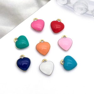Detail showing eight colorful enamel heart pendants with gold-plated metal borders