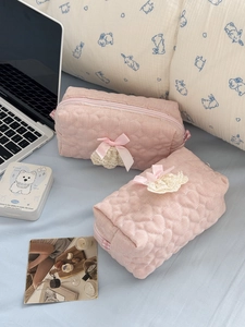 Pink heart quilted cosmetic bag set with lace trim and bows on light blue bedding