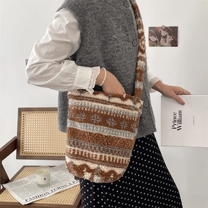 Brown and beige striped plush shoulder bag styled in a minimalist lifestyle setting
