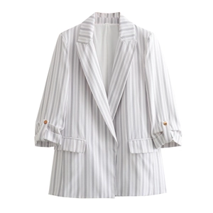 Detail of white and gray striped blazer featuring notch lapels and rolled-up button sleeves