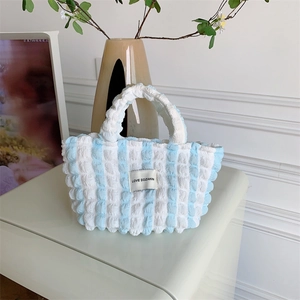 Detail of blue and white striped bubble texture fabric with LOVE SOZAKKA label
