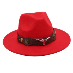 Detail of red wool felt cowboy hat featuring silver longhorn skull and leather band