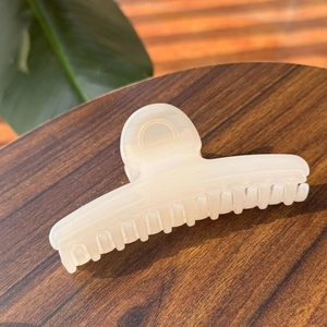 Elegant 11.5cm cream hair claw clip for women on a rustic wooden background with natural light