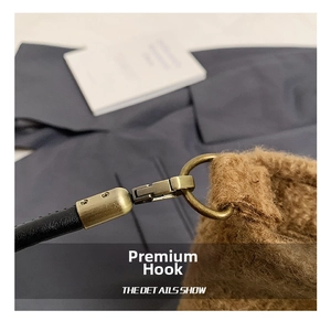 Detail of premium antique bronze hook and fuzzy brown wool texture on bucket bag