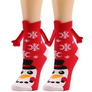 Detail of red Christmas socks with snowman pattern and magnetic hand-holding feature