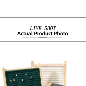 Detail view of wooden jewelry display trays with green and beige velvet slots